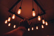 Hand Reaching For Ceiling Lights