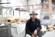 © RooM The Agency - Portrait of a smiling man sitting in a building being renovated
