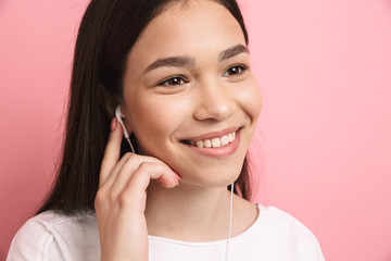 Sticker - Portrait closeup of optimistic pretty girl wearing earphones smiling while listening to music