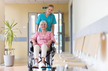 Canvas Print - Senior woman in wheelchair with nurse in hospital