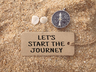 Motivational and inspirational wording - Let’s Start The Journey written on a paper tag.