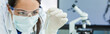 Leinwandbild Motiv Female Woman Research Scientist With Test Tube In Laboratory Panorama
