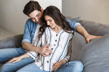 Wall Mural - Attractive young pregnant couple relaxing