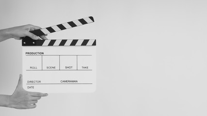 Hands is holding Clapperboard or movie slate. it use in video production ,film, cinema industry on white background.