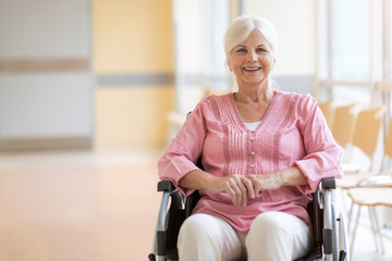 Canvas Print - Senior woman sitting in her wheelchair in hospital