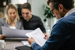 © Drazen - Real estate agent going through paperwork while having a meeting with a couple.
