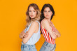 © Drobot Dean - Portrait of two offended blonde and brunette women 20s in summer wear frowning while standing back to back