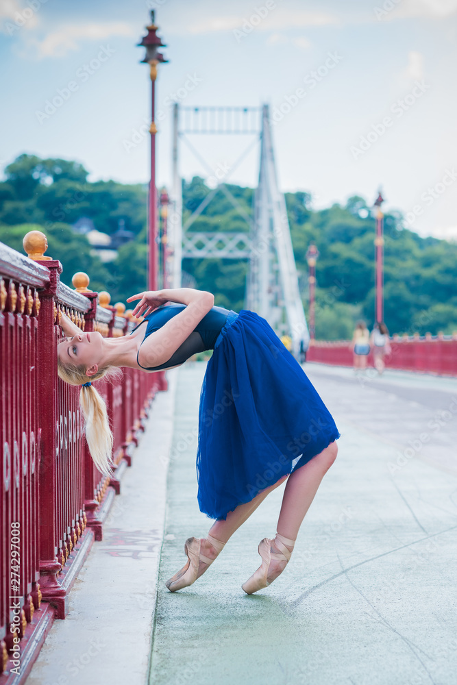 Young ballerina in ballet costume dancing in city , feeling breath of ...