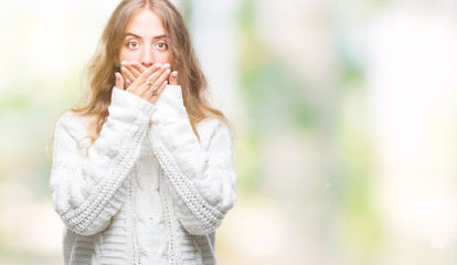 Sticker - Beautiful young blonde woman wearing winter sweater over isolated background shocked covering mouth with hands for mistake. Secret concept.