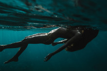 Woman Swimming In Sea