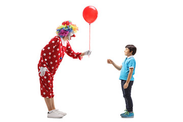 Poster - Clown giving a red balloon to a boy