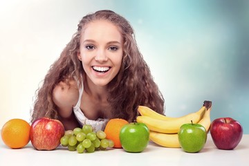 Wall Mural - Attracive young woman enjoying tea and fruits on breakfast