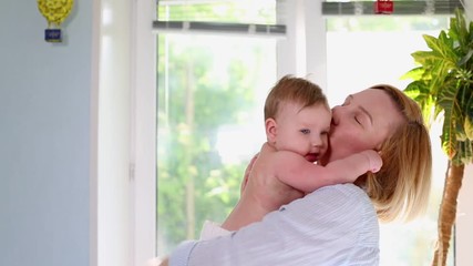 the best moments from life, a loving happy young mother hugs a nursing son, on a blue blanket with f