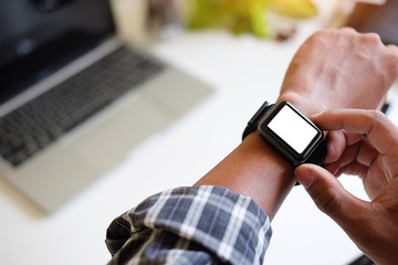 Wall Mural - cropped shot view of businessman looking at smart watch in design office .
