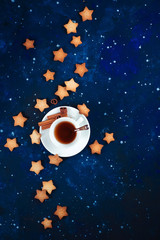Wall Mural - Teatime with star-shaped cookies. White porcelain cups on a starry sky background. Astronomy and constellation flat lay with copy space