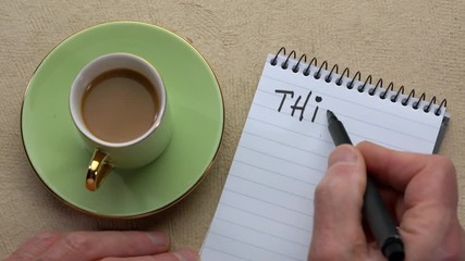 Canvas Print - think win-win - man hand writing a note with a black marker in a spiral notebook, overhead view