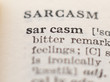 Dictionary definition of word sarcasm, selective focus.