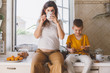 © Alena Ozerova - Pregnant mom with kid drinking tea together in the kitchen