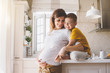 © Alena Ozerova - Pregnant mom with kid playing together in the kitchen