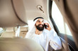 © master1305 - Arab saudi businessman working online with a smartphone, calling his clients or partners in his car. Male model as an enterpreneur. Concept of business, finance, modern technologies, start up, economy