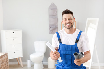 Wall Mural - Portrait of handsome plumber in restroom