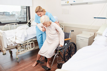 Nurse helps elderly woman in the wheelchair