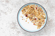 Granola, oatmeal with milk, honey and strawberry on blue plate