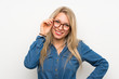 © luismolinero - Young blonde woman over isolated white wall with glasses and happy