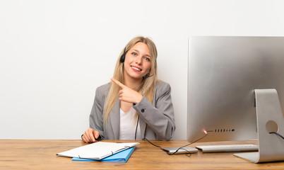 Wall Mural - Young woman working with headset pointing finger to the side