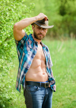 Guy Bearded Cowboy In Nature. Macho Six Packs Torso Wear Rustic Style Clothes And Cowboy Hat. Strong And Confident Cowboy. Owner Of Rancho. Man Unshaven Face Muscular Torso Cowboy. Farm Concept