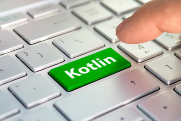 Wall Mural - kotlin computer language. the writing on button modern of gray laptop. finger presses the button. pr
