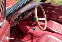 Interior View With Instruments And Wooden Steering Wheel Of An Old Red Cabriolet