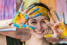 Art Therapy. Closeup Portrait Of Young Female Artist Having Fun In Studio, Smiling, Showing Hands Dirty With Paint.