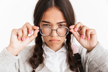 Wall Mural - Photo closeup of frustrated angry girl wearing eyeglasses frowning and expressing aversion with face