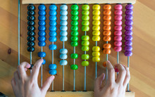 Hands Counting On Colorful Bead Abacus