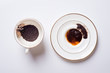 divination on coffee grounds in white cup and plate around white