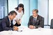 © Blue Jean Images - Business people signing contract in conference room