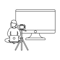 Wall Mural - woman seated using laptop with camera and monitor