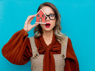 Wall Mural - Youn woman with toy house