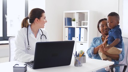 Poster - medicine, healthcare and pediatry concept - african american mother with baby son and caucasian doctor with laptop computer at clinic