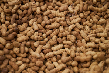 Wall Mural - Peanuts in shell texture background. Raw peanuts, top view