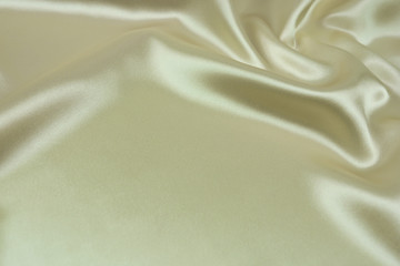 The texture of the satin fabric of beige color for the background 