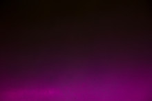 Purple Neon Color Light On Black Background. Place For Text.