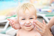 © Kirill Gorlov - Mother applying sunscreen protection creme on cute little toddler boy face. Mom using sunblocking lotion to protect baby from sun during summer sea vacation. Children healthcare at travel time