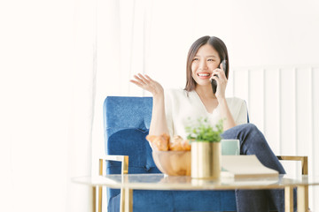 Young Asian woman using phone talking happy and smile.