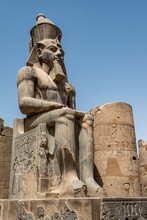 Egypt Luxor Temple. Granite Statue Of Ramesses II Seated In Front Of Columns