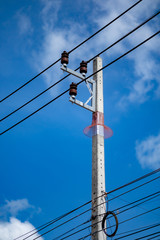 electric pole power lines with blue sky background