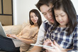 © saksit - happy asian family spending time together on sofa in living room. family and home concept