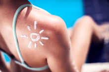 Woman With Sun Protection Cream On Her Skin In The Shape Of Sun. Summer, Healthcare And Vacation Concept