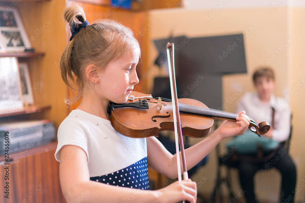 Child, little girl playing violin indoors in music class Stock Photo ...